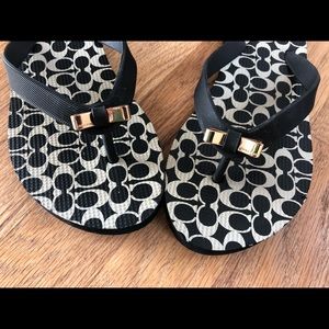 Coach flip flops with gold bow detail